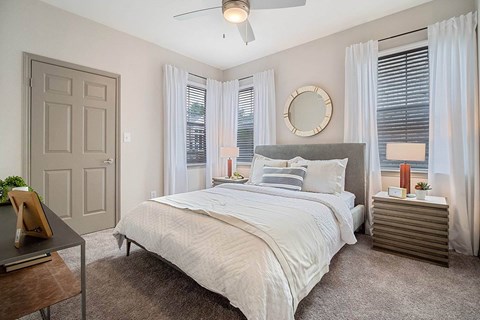 a bedroom with a bed and a ceiling fan at Creekside at Legacy, Texas